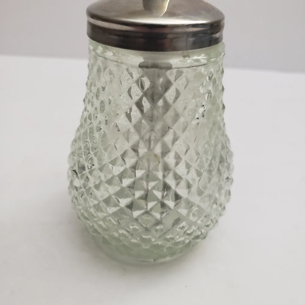 Glass sugar dispenser with a metal lid and spout. 206